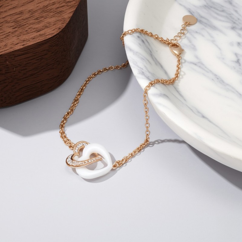 Bracelet fantaisie doubles chaînes et cœurs femme carador en plaqué or avec oxydes de zirconium et céramique blanche