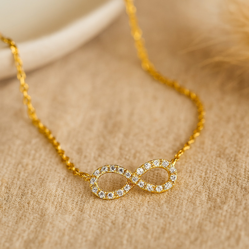Collier femme CARADOR en or jaune 750/000 et oxydes de zirconium motif infini