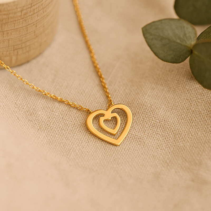 Collier fantaisie Carador en  or jaune 750/000 motif double cœurs ajourés