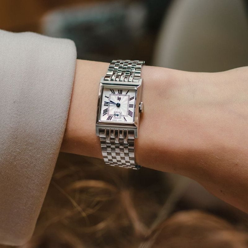 Image lifestyle de la montre Lip Churchill C18 portée au poignet, avec son boîtier carré et son allu