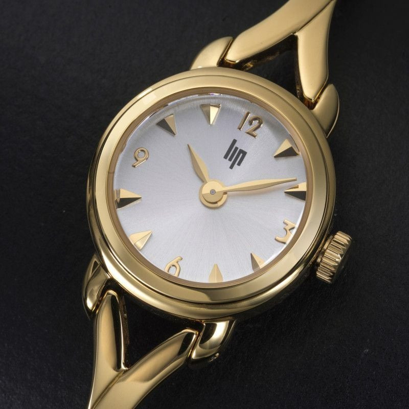 Montre femme quartz LIP Henriette Semi Rigide bracelet en métal doré, mise en scène élégante sur fon