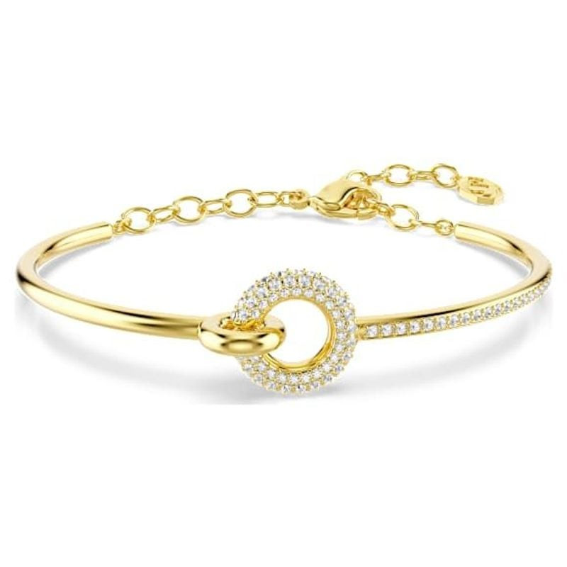 Bracelet jonc Swarovski Dextera doré avec motif circulaire en cristaux pavés sur fond blanc