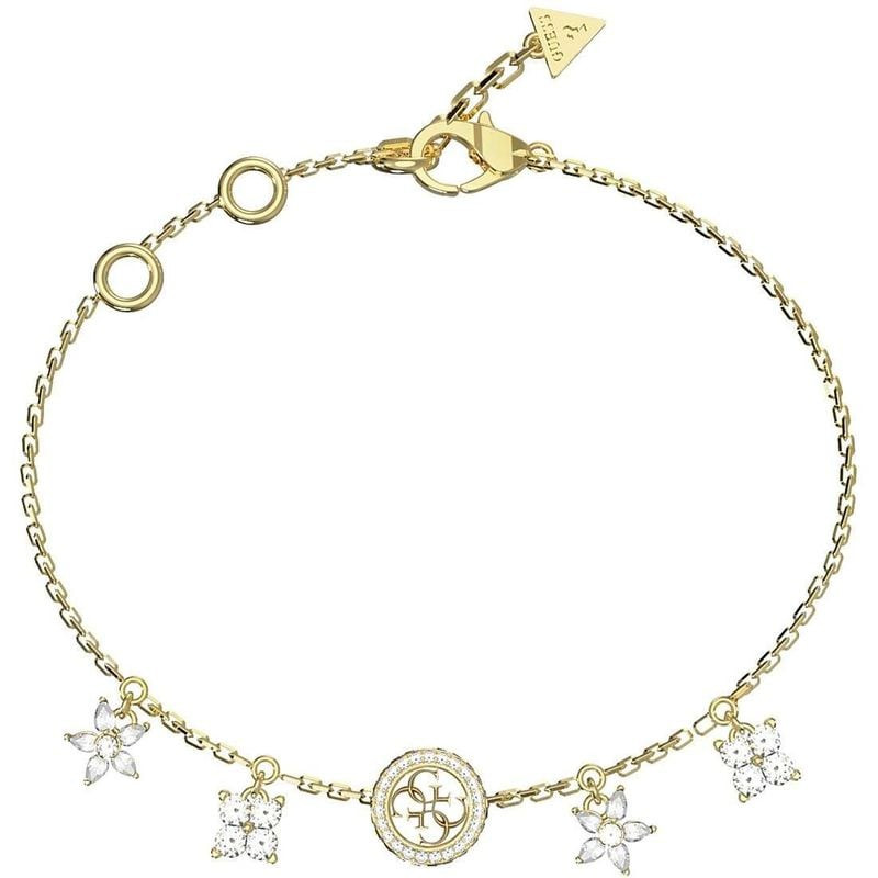 Bracelet GUESS Secret Garden acier doré posé à plat, breloques fleurs cristal blanc, médaille logo e