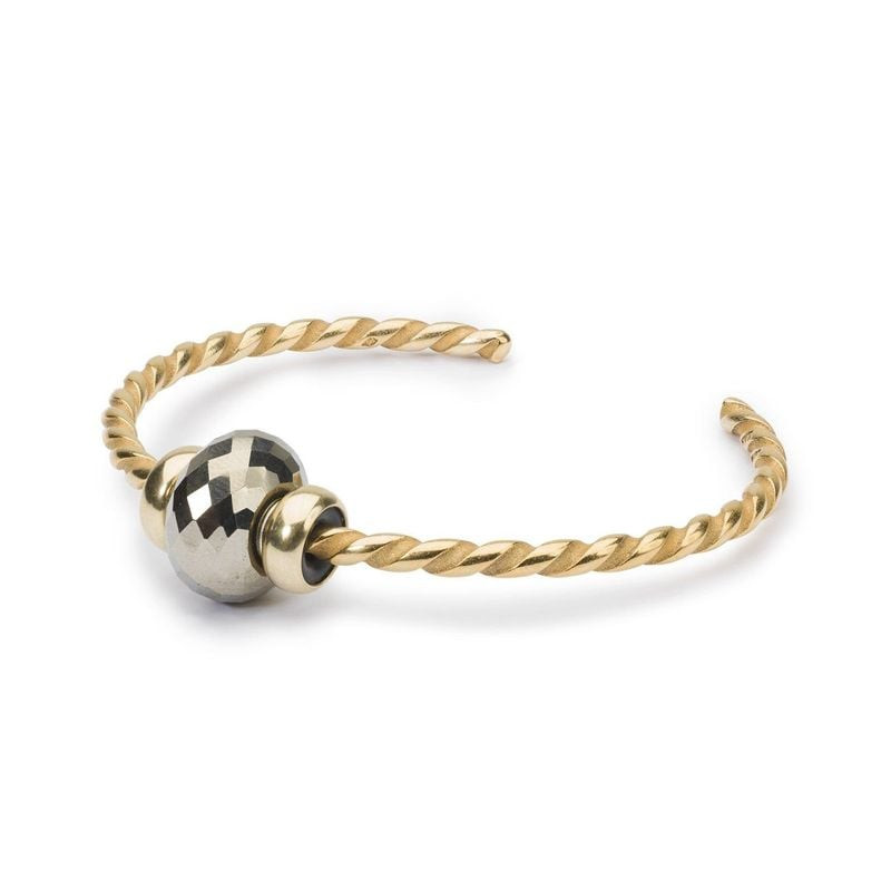 Perle Trollbeads Stardust Facettée Pierre Gemme Doré dans une ambiance dorée et scintillante