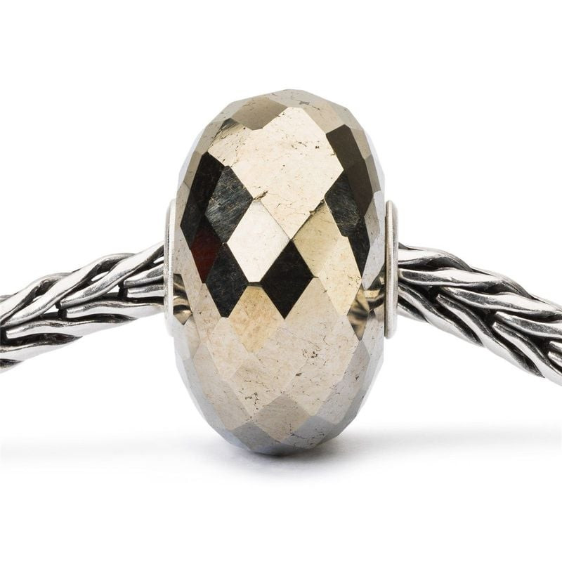 Packshot de la Perle Trollbeads Stardust Facettée Pierre Gemme Doré sur fond neutre