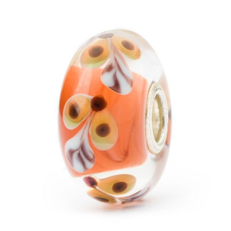 Perle en verre Trollbeads Joyeux Grimpeur faite main, base orange, motif floral blanc et noyau en ar
