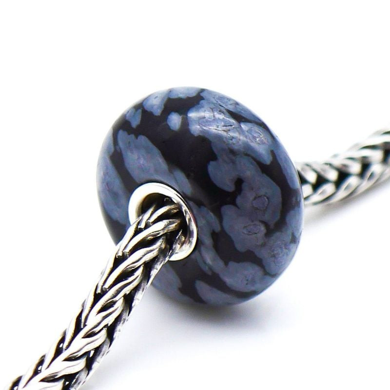 Perle de Charme Trollbeads Flocon Obsidienne Noir dans une ambiance minérale et élégante