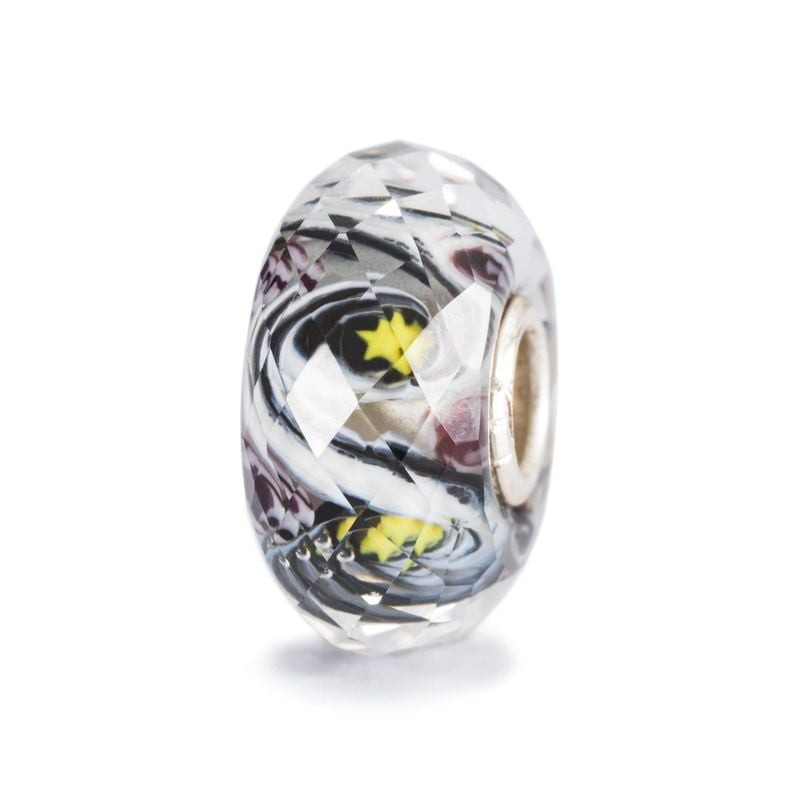 Perle Trollbeads Espoir à facettes en verre avec surface facettée et motif étoile jaune sur fond bla