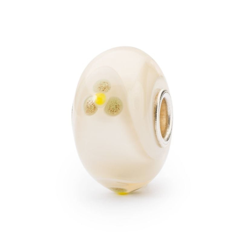 Perle de verre Trollbeads Paradis du Tatou ivoire, motif tatou floral et cœur en argent sur fond bla