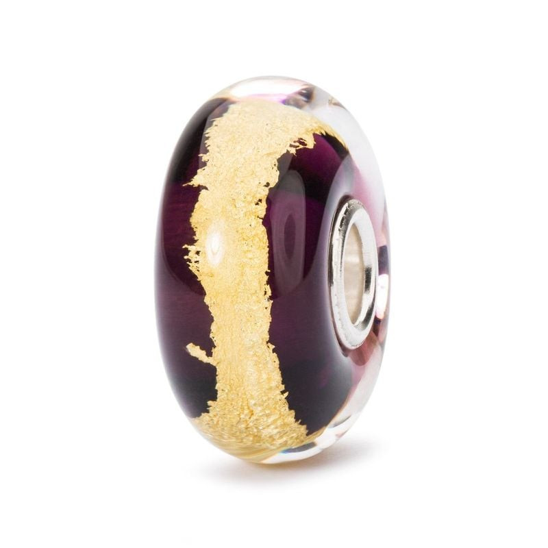 Perle Trollbeads Troisième œil en verre violet profond avec feuille d'or 22 carats, vue de côté sur 