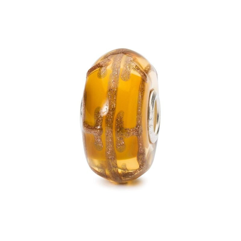 Perle de verre Trollbeads Série Rêverie Dream Blaze aux tons ambre et doré, volutes scintillantes su