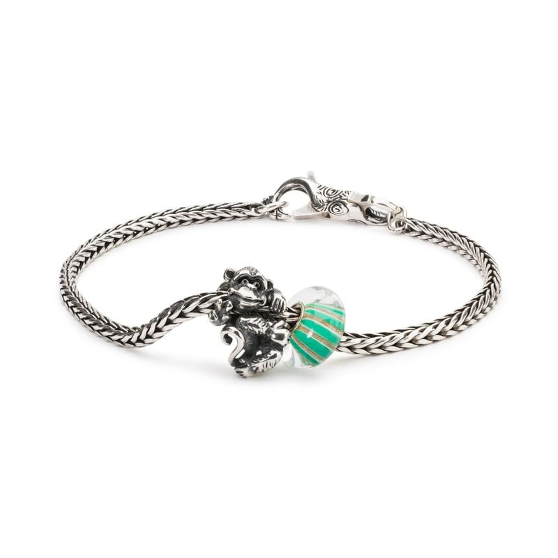 Perle TROLLBEADS Rayon scintillant associée à une breloque singe sur un bracelet argent.