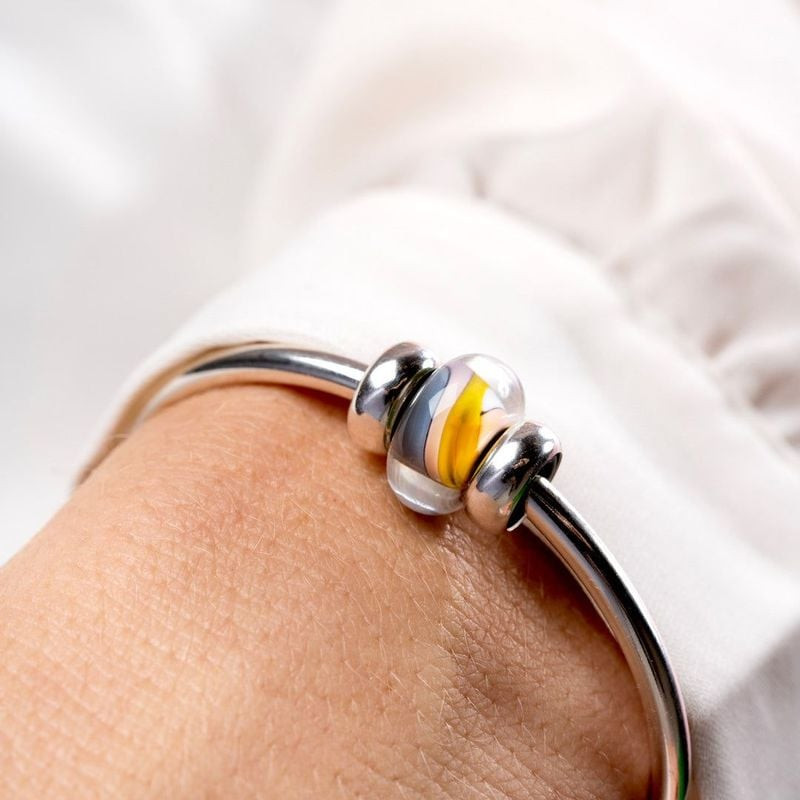 Détail du charm Trollbeads Douceur en verre multicolore et argent 925, finition artisanale.