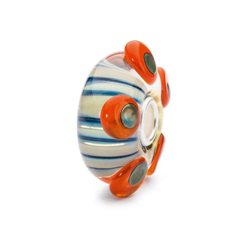 Gros plan de la perle Trollbeads Étamine de vie en verre, points orange irisés et cœur en argent.