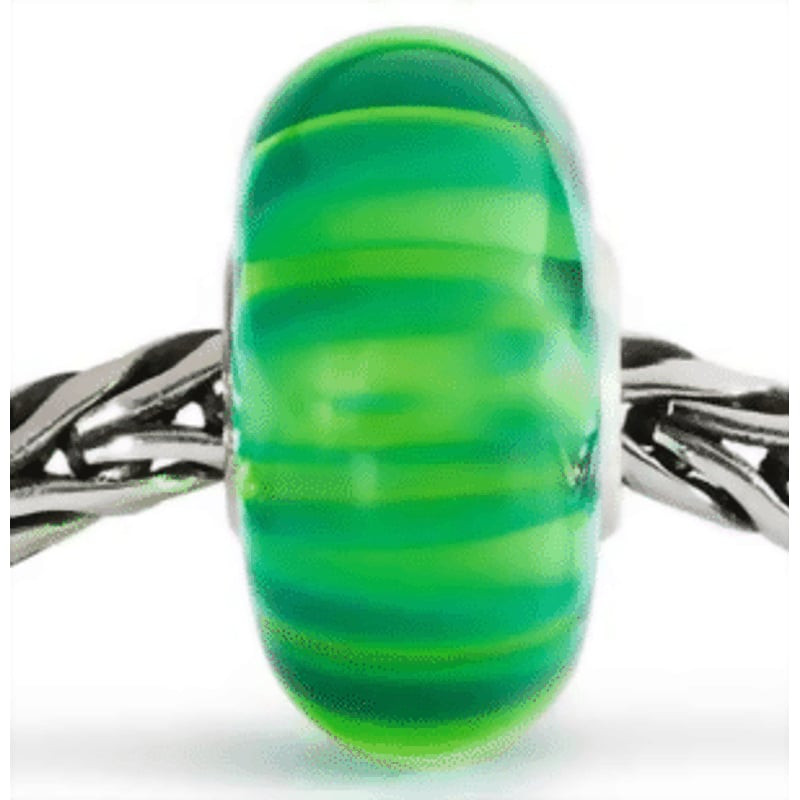 Perle Trollbeads Tiges Oscillant au Vent Verre posée sur un bracelet, dans une ambiance naturelle et