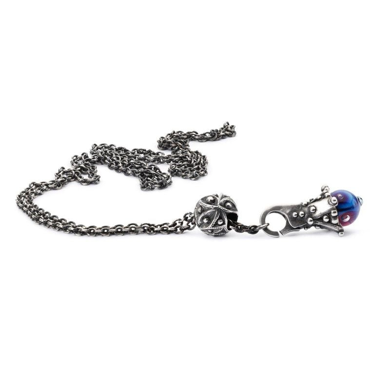 Pendentif Trollbeads Ressentez la pluie en argent, chaîne argentée enroulée sur fond blanc près d'un