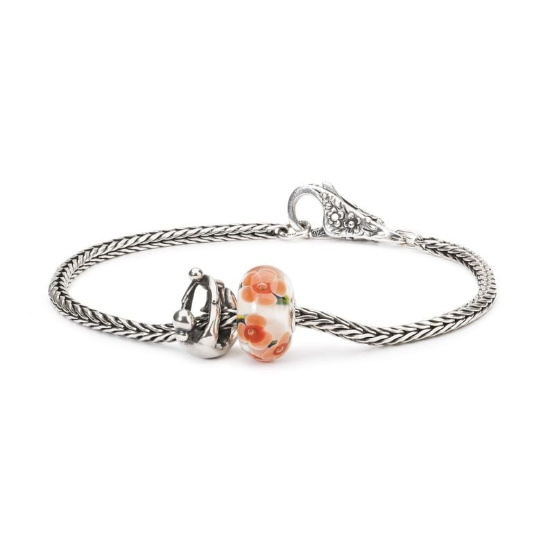 Bracelet Trollbeads en argent avec la perle Paternité et une perle de verre florale.