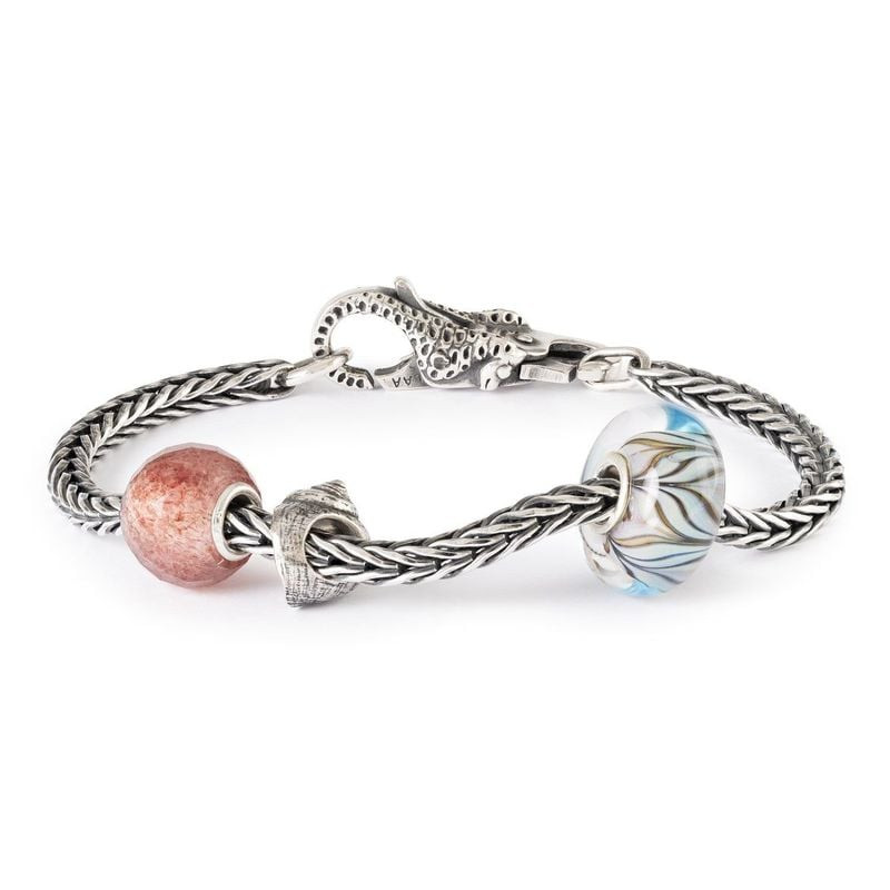 Perle Trollbeads Coquillage Argenté dans une ambiance océanique douce, reflets argentés et vagues ap