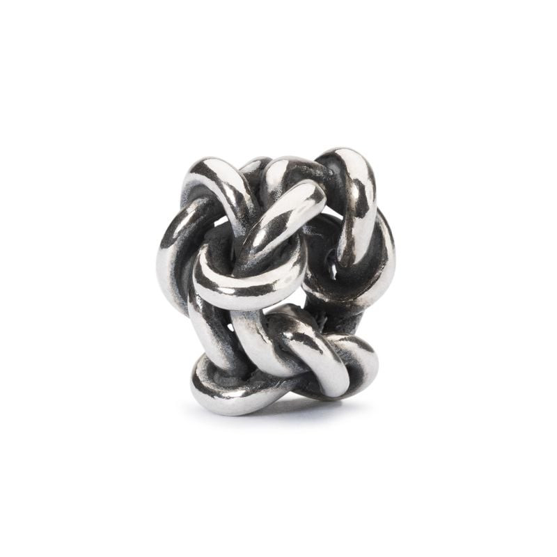 Perle Trollbeads Nœud de l'amitié en argent 925 avec nœud entrelacé poli sur fond blanc.