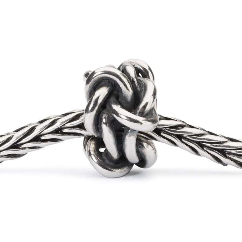 Perle charm Trollbeads Nœud de l'amitié en argent, enfilée sur un bracelet tressé Trollbeads, vue ra