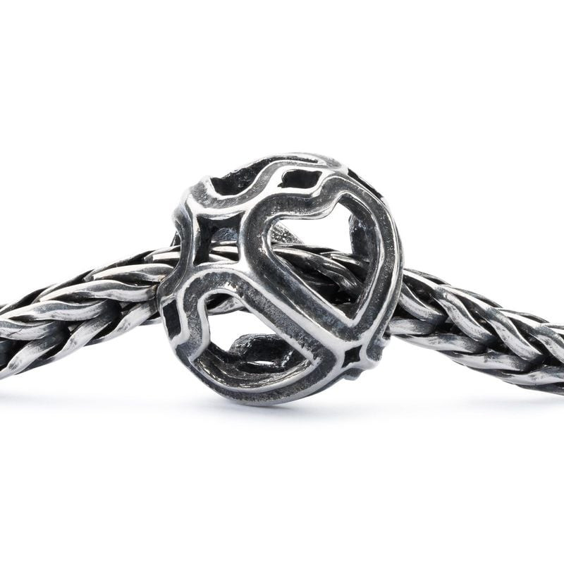 Perle Trollbeads Symphonie de Cœurs en argent sur bracelet tressé Trollbeads en gros plan