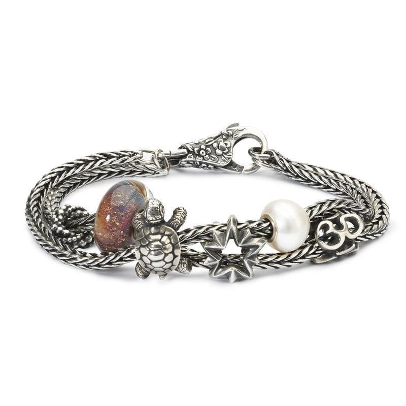 Charm TROLLBEADS Étoile du berger en argent sur bracelet tressé avec perles tortue, nacre et verre