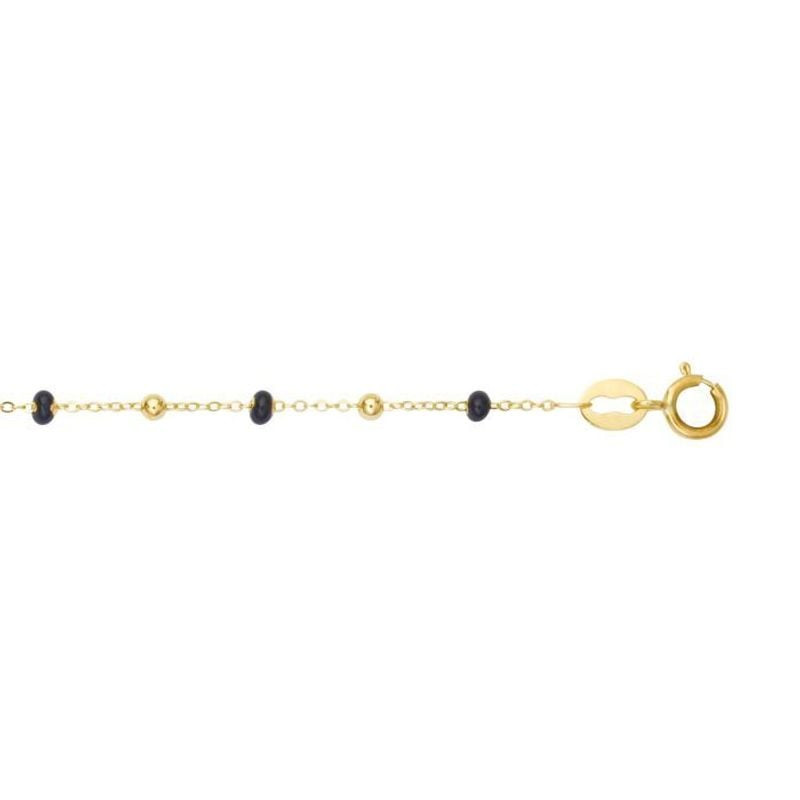 Bracelet en or jaune 18 carats avec billes noires laquées sur chaîne fine, posé à plat, fermoir à an